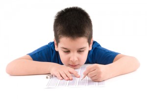 boy fills out a Cognitive Abilities Test bubble sheet