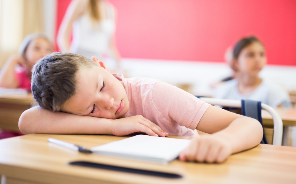 Child asleep in school.